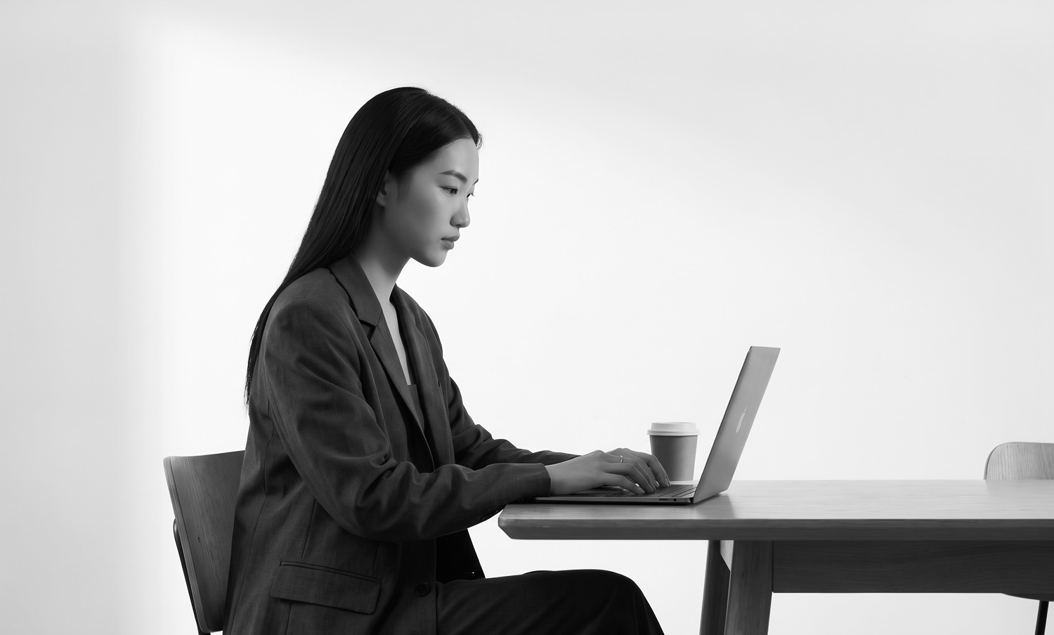 Woman working on a laptop at a desk